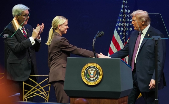 U.S. President Donald Trump shakes hands with U.S. Attorney General Pamela Bondi for the second hearing on religious liberty in public education.
